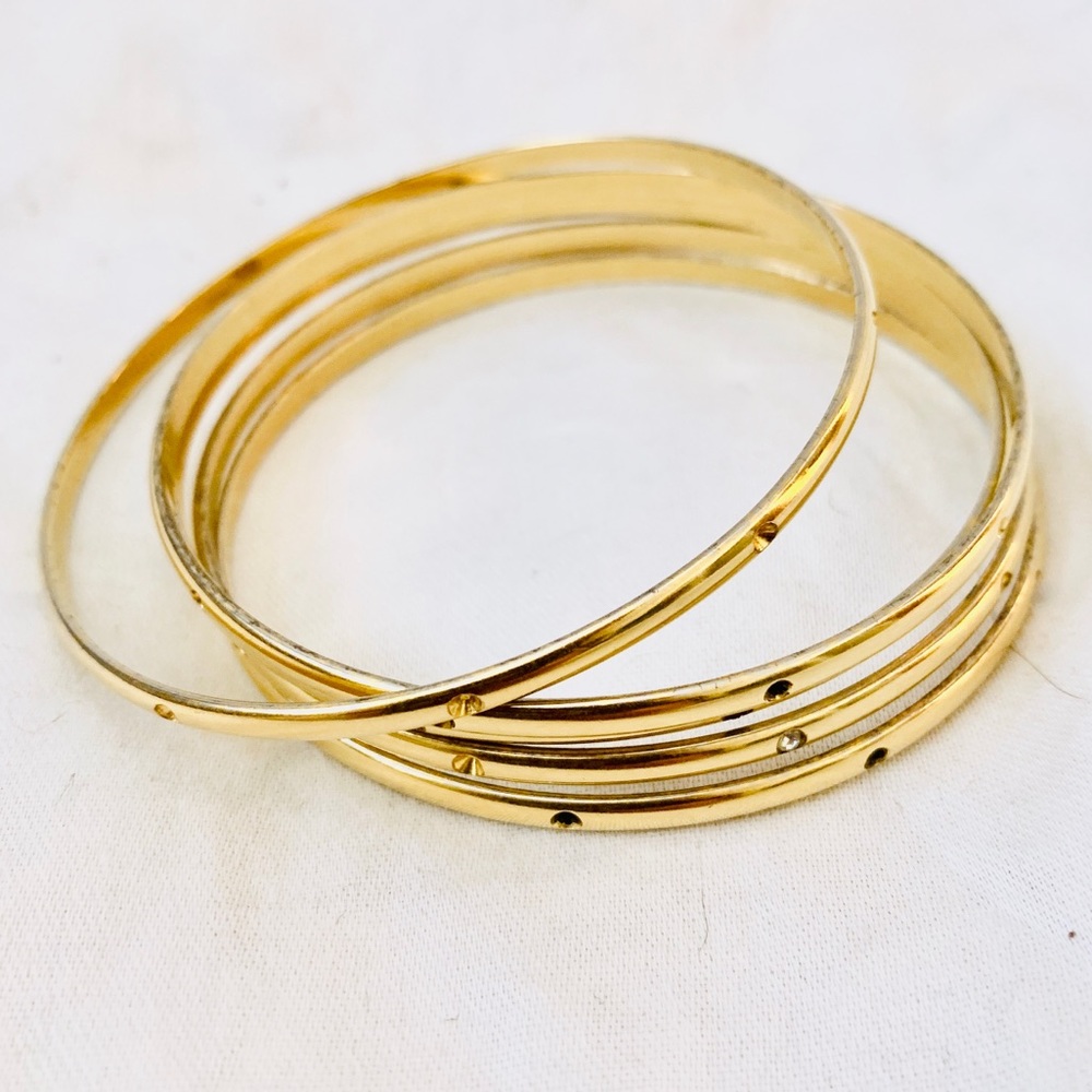 Gold metal set of bangles with gem details